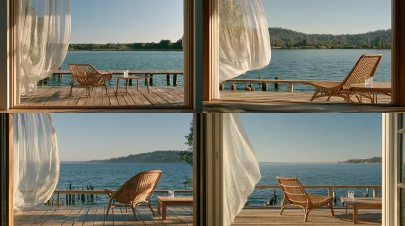 photoreal live-action establishing plate of a lakeside wooden veranda in summer, 16:9 horizontal frame. camera at the interior doorway, 1.3 meters high, level 28mm view toward the water. the doorway frames the scene, floorboard seams form leading lines, and a translucent white curtain occupies the near-left foreground. clear water and a softly detailed far bank provide forty percent negative space. a light-brown woven rattan chair faces diagonally toward the lake; a low rectangular wooden table stands on its seated occupant’s right, holding only one clear tumbler of water and a few ice cubes. a low wooden railing borders the veranda, with timber piles entering the lake below. the curtain has just lifted enough to reveal the doorframe. cool-white 3 p.m. sunlight enters from rear-left outdoors; lake reflections and a pale doorway wall illuminate the shaded veranda. real wood, rattan, cotton voile and transparent glass, practical location, arri alexa mini lf, fine 35mm grain with clear saturated 2000s dv color, subtle halation, readable shadows, no readable text
