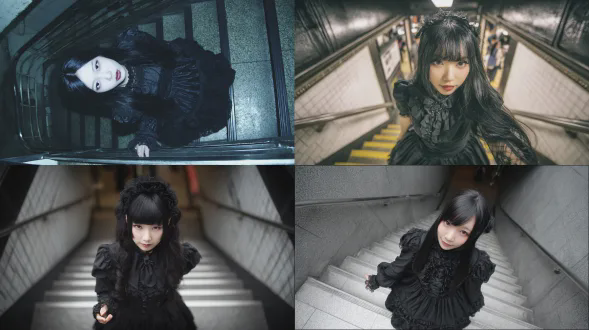 不对称构图，仰拍视角，背景为地铁楼梯口，清透，超长黑发，黑色哥特 lolita 连衣裙，衣服细节丰富。发量多，发型修饰脸型显脸小。身形纤细，皮肤白皙，小清新，站在楼梯上，一只手伸出来对着镜头，动作可爱。美女毛孔清晰可见，细腻肌理。摄影艺术，人像摄影
