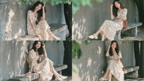 写实肖像，一位美丽的年轻东亚女性，长发柔软黑亮，笑容甜美灿烂，坐在风化了的户外混凝土长椅上，身旁是纹理粗糙的灰色混凝土墙，柔和的斑驳夏日光线洒落。她身穿米白色v领短袖中长连衣裙，裙上点缀着精致的小红色花卉图案，脚踩白色低跟露趾凉鞋，手腕上戴着细金手镯，肩上挎着棕色皮革肩包，一只手轻轻抚着头发，姿态放松随意。远处背景是模糊的绿色树叶，画面右侧有部分深色树干虚化，柔和的自然太阳光晕，微妙的胶片颗粒质感，柯达portra 400胶片，浅景深，柔光，温暖舒适的日常氛围，使用85mm f/1.4镜头拍摄。避免 ai 美女脸、低质量、模糊、扭曲、多余肢体、多余手指、畸形特征、过度、不足、噪点、粗糙皮肤、肤色暗沉、表情僵硬、过度平滑、塑料质感、水印、文字、边框、过度精修、塑料皮肤、暗沉肤色、明显痘印、明显皱纹、斑点、面部变形。