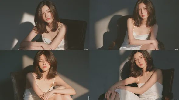 年轻优雅的东亚女性，齐肩柔软棕色中长发，面部特征柔和，身穿简约白色细吊带连衣裙，坐在复古深色实木扶手椅上，双臂交叉放于膝上，柔和的斜射黄金时刻阳光洒在面部和身上，哑光深灰色墙壁背景上投下长而柔和的阴影，写实人像摄影，kodak portra 400胶片，细微胶片颗粒，自然细腻的皮肤质感，柔和温暖的色调，浅景深，安静柔和的氛围，无夸张效果。避免 ai 美女脸、低质量、模糊、扭曲、多余肢体、多余手指、畸形特征、过度、不足、噪点、粗糙皮肤、肤色暗沉、表情僵硬、过度平滑、塑料质感、水印、文字、边框、过度精修、塑料皮肤、暗沉肤色、明显痘印、明显皱纹、斑点、面部变形。