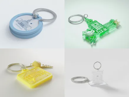 3d render of a graduation commemorative keychain, made of recycled pet plastic from waste bottles, 3d printed in the shape of a university landmark, laser engraved with student id and name, with xiaolu yoyo cartoon pendant, minimalist trendy design, soft lighting, octane render, 8k, ultra detailed, white background, product photography