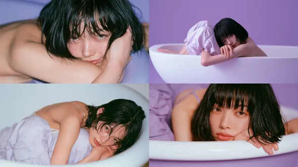 photorealistic editorial portrait. a 20 year old japanese woman, soft oval face, gentle almond eyes, natural brows, small nose, softly defined lips, soft smile, sleek wet black bob. tall slender figure. prone in an empty dry bathtub, torso face down, body deeply curled, knees drawn to chest, spine rounded compact, one hand beside face, other arm along body. wears silk camisole and balloon cargo pants. seamless saturated pure purple background and ground blending into a continuous purple void, no corners. warm low light amber interior, hard direct on camera flash, bright highlights, crisp compact shadows. inspired by rinko kawauchi: airy high key, pale overexposed daylight, cool pastels, delicate everyday realism. 85mm f/2.0, compressed perspective, shallow depth of field, optical vignetting. early 2000s compact digital ccd rendering, on camera flash glare, low resolution softness, narrow dynamic range, clipped highlights, crushed noisy shadows.