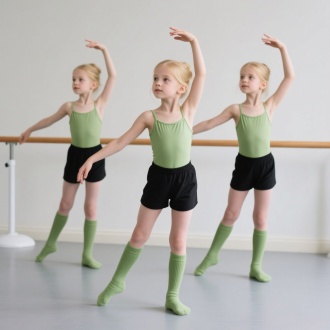 模特在舞蹈房练功，有3个女模特，穿着牛油果绿吊带连体服，搭配黑色三分短裤，穿着牛油果绿的现代舞袜，皮肤白皙，头发是金色，外模，模特年龄在6-8岁，模特做着舞蹈动作。舞蹈房背景干净，有舞蹈把杆。要求图片高清，展示模特的全身或者是半身